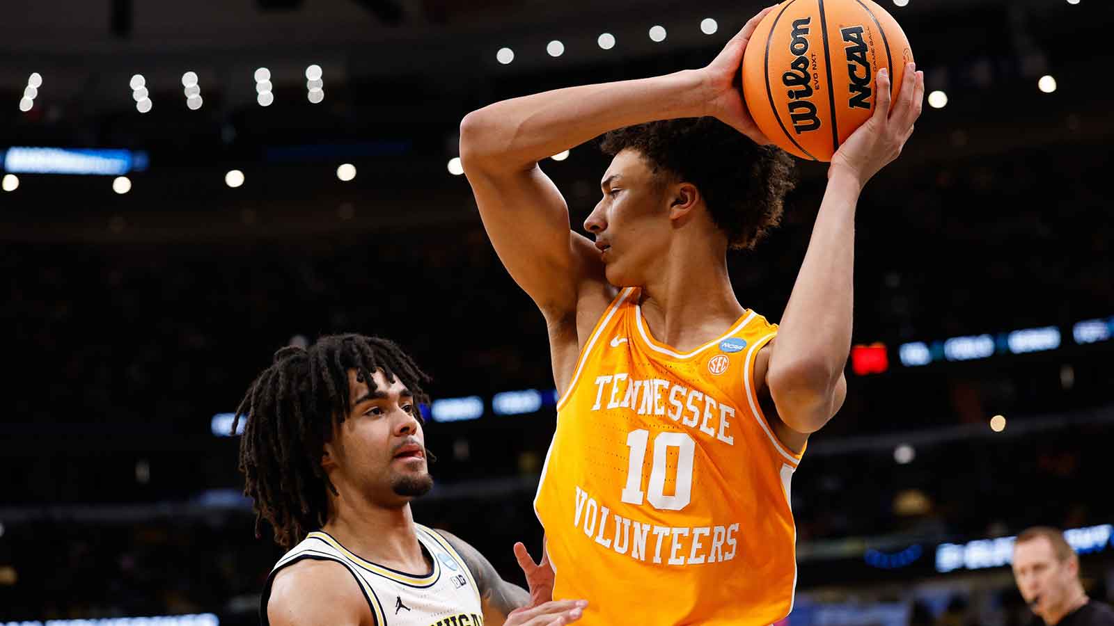 Tennessee Volunteers forward Nate Ament (10) looks to pass while defended by Michigan Wolverines guard Elliot Cadeau (3) in the first half during an Elite Eight game of the Midwest Regional of the men's 2026 NCAA Tournament at United Center