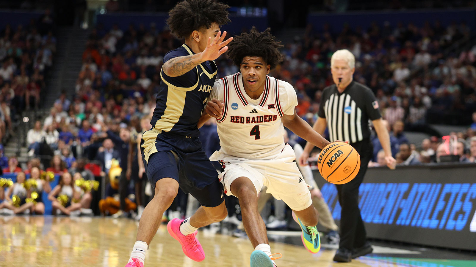 Texas Tech Red Raiders guard Christian Anderson (4) drives against Akron Zips guard Sharron Young (3) in the second half during a first round game of the men's 2026 NCAA Tournament at Benchmark International Arena.