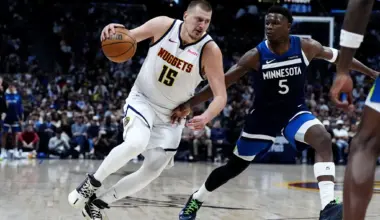 Minnesota Timberwolves guard Anthony Edwards (5) defends Denver Nuggets center Nikola Jokic (15) in the second half at Ball Arena.