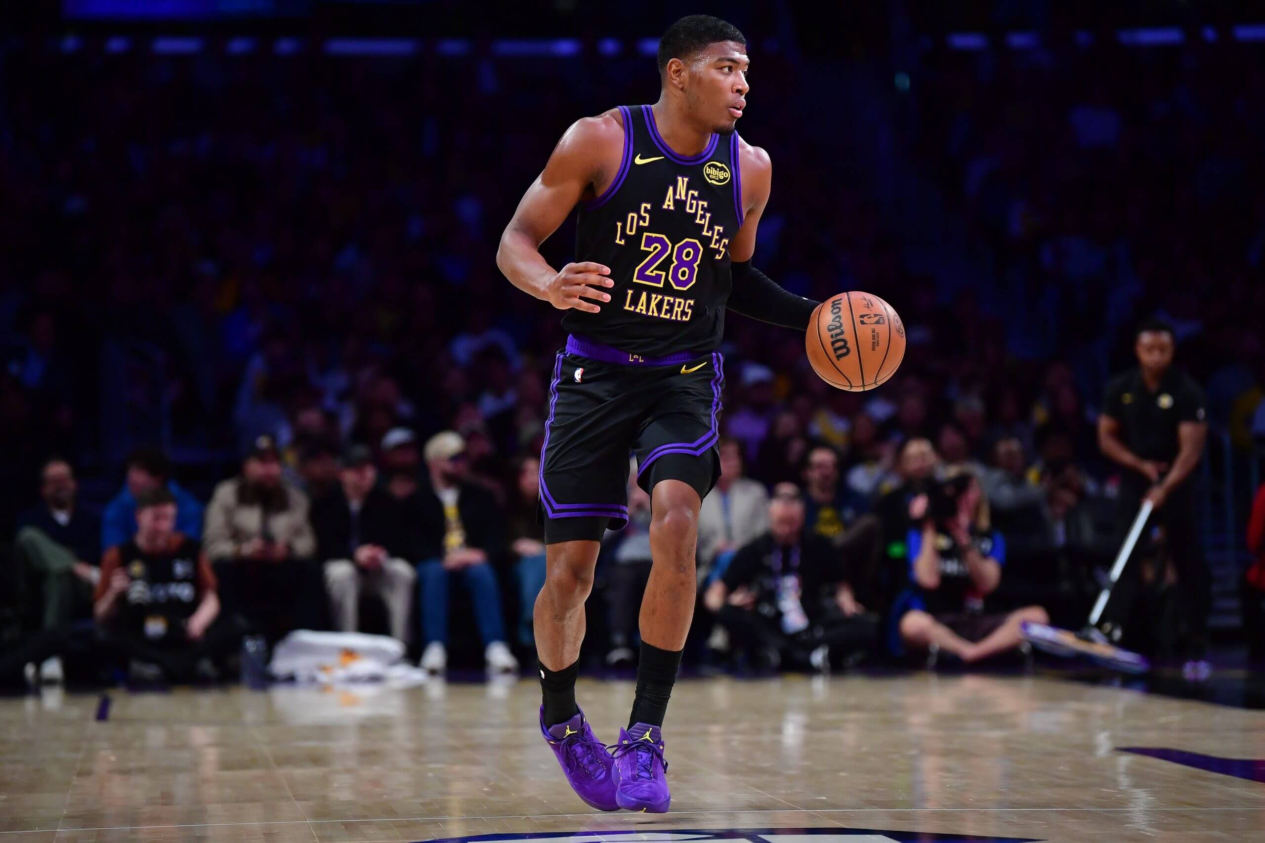 An image of Los Angeles Lakers forward Rui Hachimura dribbling down the court with his left hand during an NBA game.