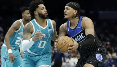 Mar 19, 2026; Charlotte, North Carolina, USA; Orlando Magic forward Paolo Banchero (5) tries to drive to the basket past Charlotte Hornets forward Miles Bridges (0) during the third quarter at Spectrum Center. Mandatory Credit: Brian Westerholt-Imagn Images