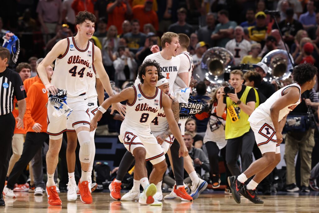 Illinois Fighting Illini center Zvonimir Ivisic (44) and guard Blake Fagbemi (8) celebrate after defeating the Iowa Hawkeyes in an Elite Eight game of the South Regional of the men's 2026 NCAA Tournament at Toyota Center.
