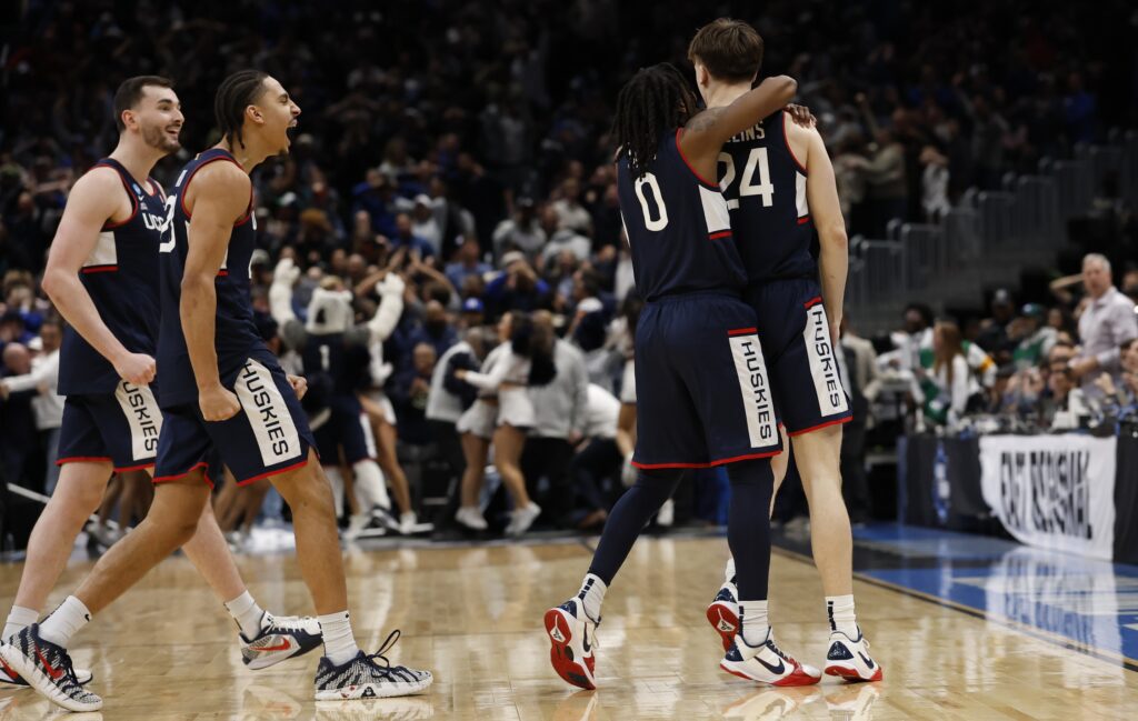 UConn Huskies guard Malachi Smith (0) celebrates with UConn Huskies guard Braylon Mullins (24) after a game-winning three-point basket against the Duke Blue Devils in the second half during an Elite Eight game of the East Regional of the men's 2026 NCAA Tournament at Capital One Arena