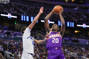 Mar 31, 2026; Orlando, Florida, USA; Phoenix Suns forward Rasheer Fleming (20) goes to the basket against Orlando Magic guard Jett Howard (13) during the second quarter at Kia Center. Mandatory Credit: Mike Watters-Imagn Images