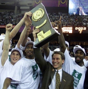 Michigan State coach Tom Izzo lifts the NCAA championship trophy after the win over Florida, April 3, 2000 at the RCA Dome in Indianapolis. Mateen Cleaves is at right. © Eric Seals / USA TODAY NETWORK via Imagn ImagesMsu Florida Championship Basketball