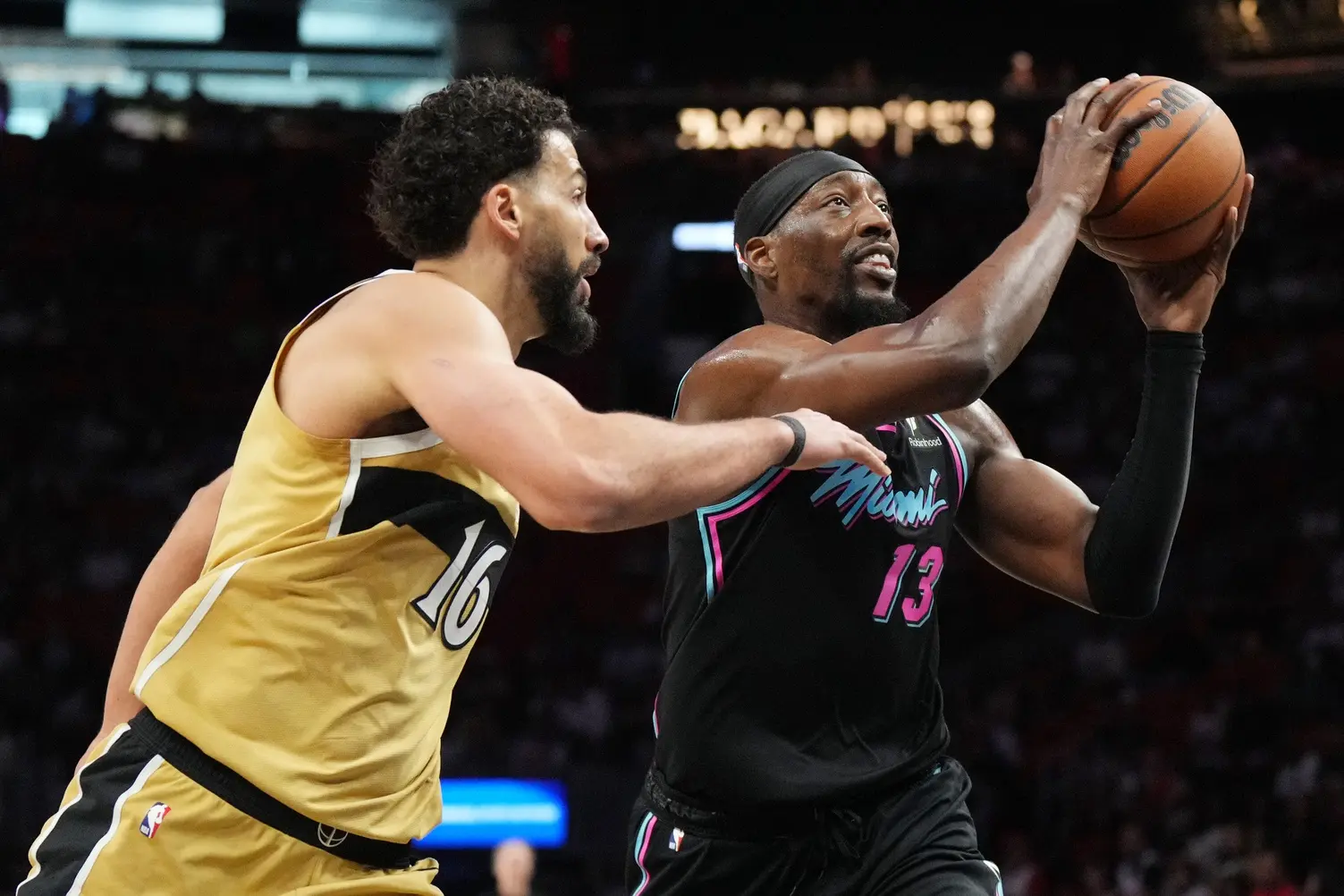 Apr 4, 2026; Miami, Florida, USA; Miami Heat center Bam Adebayo (13) drives to the basket as Washington Wizards forward Anthony Gill (16) defends during the first half at Kaseya Center. Mandatory Credit: Jim Rassol-Imagn Images