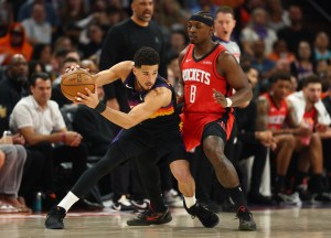 Apr 7, 2026; Phoenix, Arizona, USA; Phoenix Suns guard Devin Booker (1) controls the ball against Houston Rockets forward Jae'Sean Tate (8) in the first half at Mortgage Matchup Center. Mandatory Credit: Mark J. Rebilas-Imagn Images