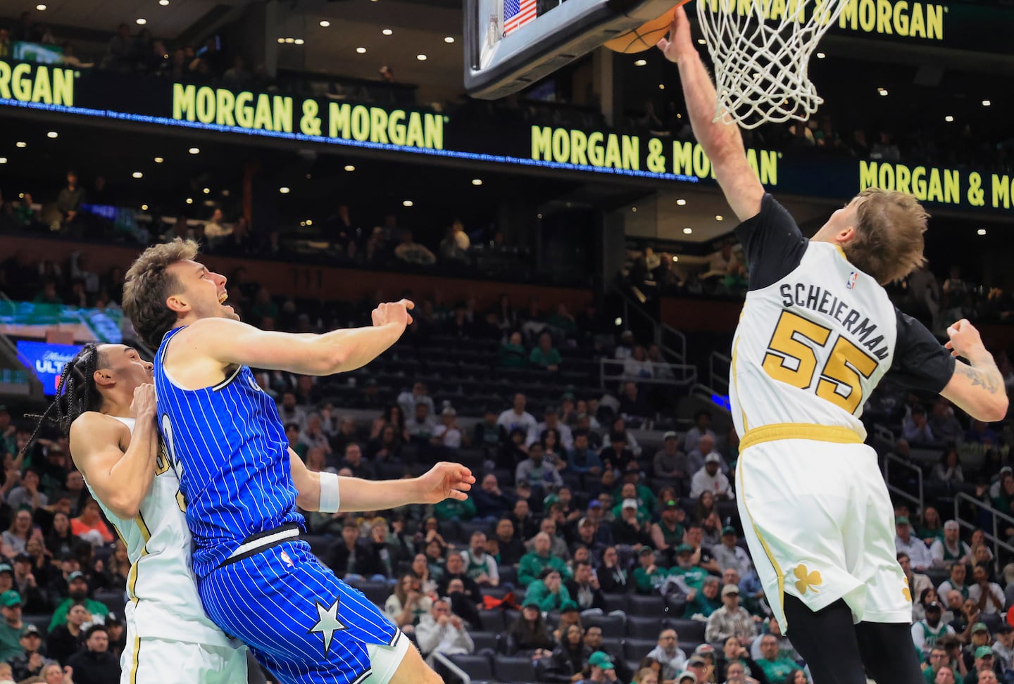 Baylor Scheierman (55) makes a key block of a bid by Orlando's Franz Wagner (left) late in the fourth quarter of Sunday night's Celtics win.