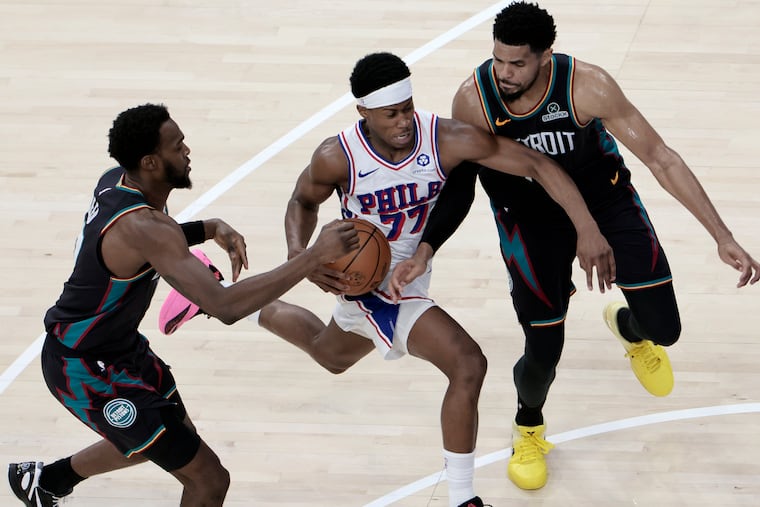Pistons Paul Reed (left) and Tobias Harris (right) squeeze Sixers VJ Edgecombe as he charges down the court in the second half of the Detroit Pistons at Philadelphia 76ers (Sixers) NBA game at Xfinity Mobile Arena in Philadelphia on Saturday, April 4, 2026.