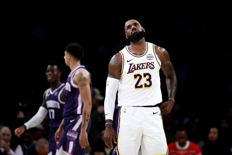 Lakers forward LeBron James tilts his back as he reacts to a play against the Kings.