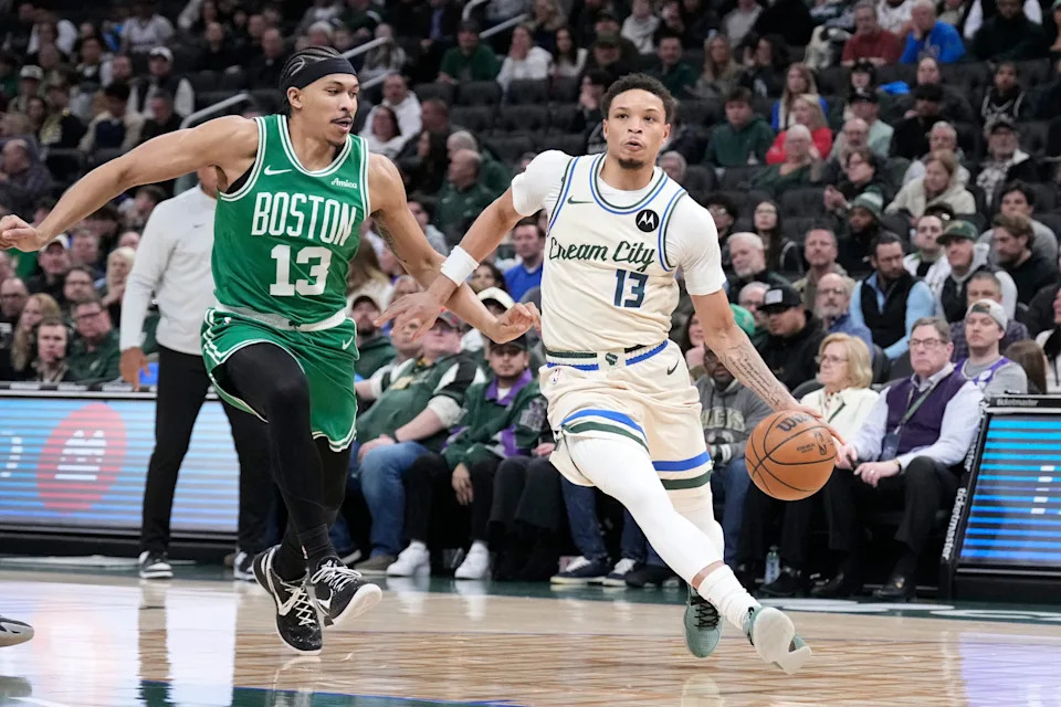 Mar 2, 2026; Milwaukee, Wisconsin, USA; Milwaukee Bucks guard Ryan Rollins (13) drives to the basket against Boston Celtics guard Ron Harper Jr. (13) in the first half at Fiserv Forum. Mandatory Credit: Michael McLoone-Imagn Images