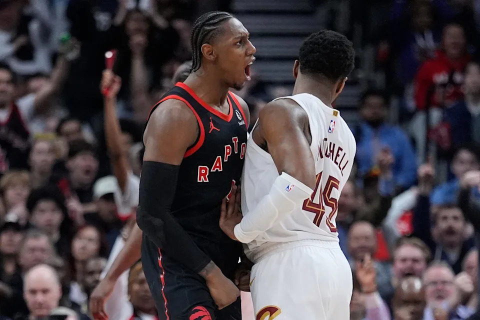 Toronto Raptors forward RJ Barrett celebrates as Cleveland Cavaliers guard Donovan Mitchell (45) tries to walk away during Game 3 of an NBA playoffs first-round series April 23, 2026, in Toronto, Ontario.