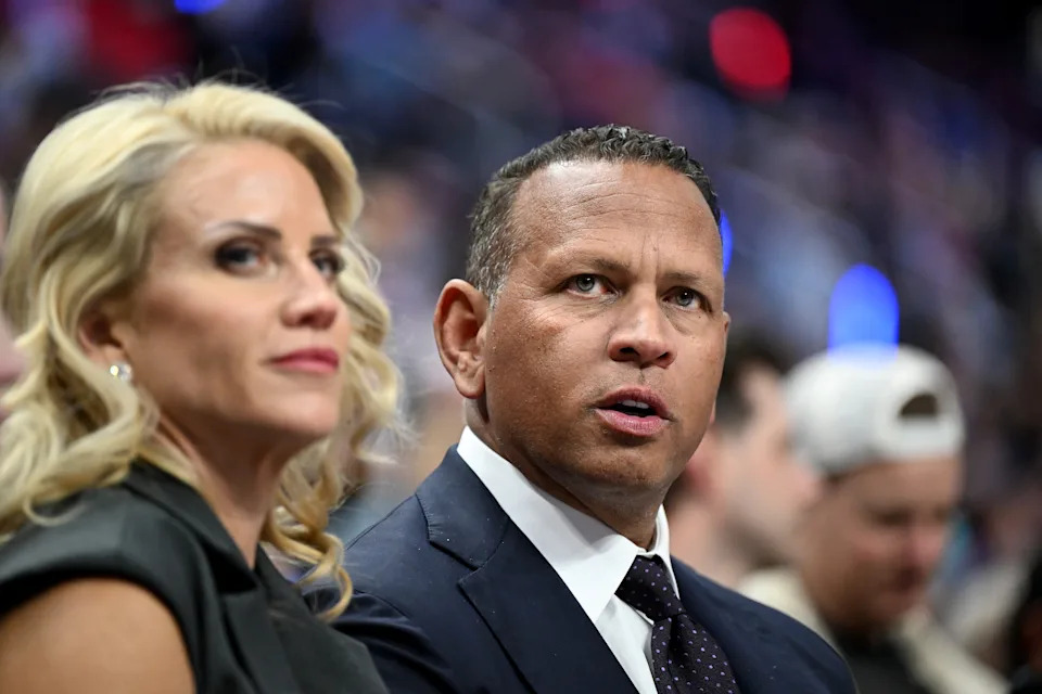 Minnesota Timberwolves controlling owner and former Major League Baseball player, Alex Rodriguez, watches the Timberwolves play the Detroit Pistons with his girlfriend Jaclyn Cordeiro, in the first half of an NBA basketball game Thursday, April 2, 2026, in Detroit. (AP Photo/Lon Horwedel)