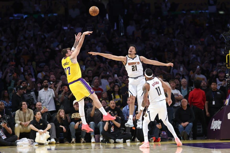 Luka Doncic of the Los Angeles Lakers shoots a winning jumpshot past Spencer Jones of the Denver Nuggets during overtime of a game at Crypto.com Arena on March 14, 2026 in Los Angeles, California. The Los Angeles Lakers defeated the Denver Nuggets 127-125. (Photo by Sean M. Haffey/Getty Images)