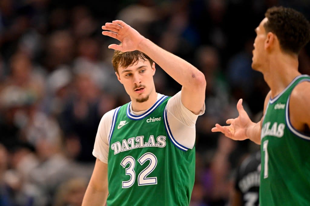 Dallas Mavericks forward Cooper Flagg (32) and forward Dwight Powell (7) celebrates Flagg making a three point basket against the Orlando Magic during the second half at the American Airlines Center. IMAGN IMAGES via Reuters Connect