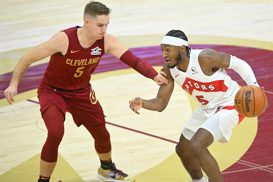 Jan 9, 2025; Cleveland, Ohio, USA; Cleveland Cavaliers guard Sam Merrill (5) defends Toronto Raptors guard Immanuel Quickley (5) in the fourth quarter at Rocket Mortgage FieldHouse. Mandatory Credit: David Richard-Imagn Images