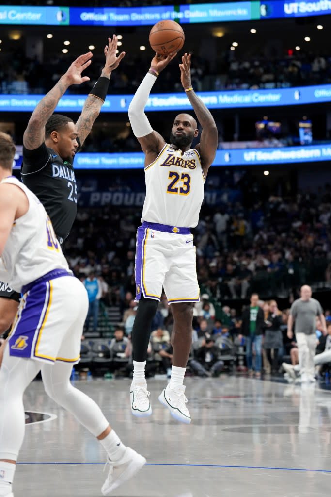 LeBron James of the Los Angeles Lakers shoots a three point basket during the game against the Dallas Mavericks. NBAE via Getty Images