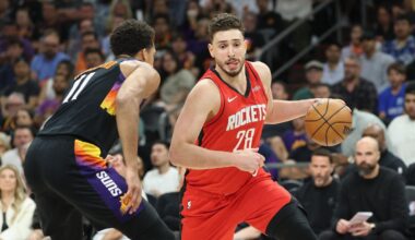 Alperen Sengun (#28) of the Houston Rockets dribbles past Oso Ighodaro (#11) of the Phoenix Suns in the second half at Mortgage Matchup Center in Phoenix, Arizona, April 7, 2026. (AFP Photo)