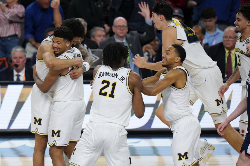 Michigan players celebrate after the final buzzer.