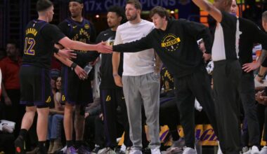 Los Angeles Lakers guard Luka Doncic (77) and guard Austin Reaves (15) high five forward Jake LaRavia (12) in the first half of game two of the first round of the 2026 NBA Playoffs against the Houston Rockets at Crypto.com Arena. Mandatory Credit: Jayne Kamin-Oncea-Imagn Images