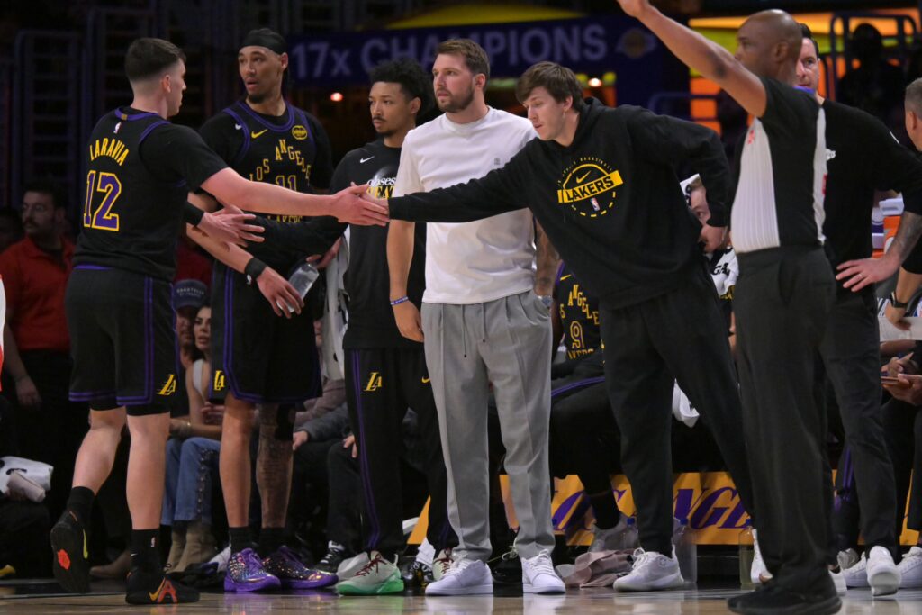 Los Angeles Lakers guard Luka Doncic (77) and guard Austin Reaves (15) high five forward Jake LaRavia (12) in the first half of game two of the first round of the 2026 NBA Playoffs against the Houston Rockets at Crypto.com Arena. Mandatory Credit: Jayne Kamin-Oncea-Imagn Images