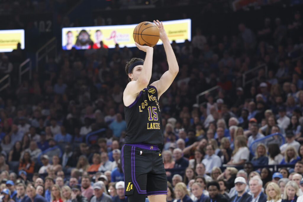 Oklahoma City, Oklahoma, USA; Los Angeles Lakers guard Austin Reaves (15) shoots a three point basket against the Oklahoma City Thunder during the first quarter at Paycom Center. Mandatory Credit: Alonzo Adams-Imagn Images