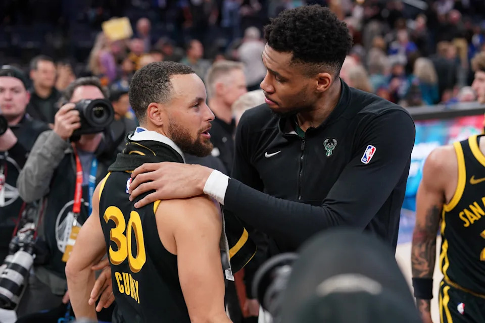 Milwaukee Bucks forward Giannis Antetokounmpo and Golden State Warriors guard Stephen Curry meet after a game.© Cary Edmondson-Imagn Images