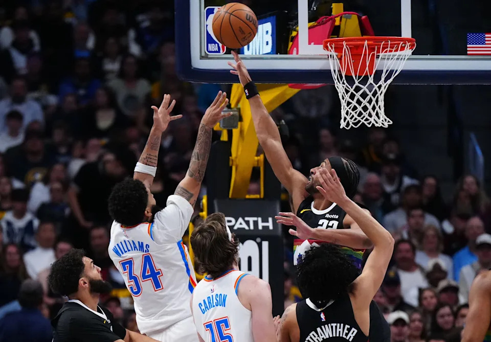 Apr 10, 2026; Denver, Colorado, USA; Oklahoma City Thunder guard Kenrich Williams (34) shoots the ball over Denver Nuggets forward Zeke Nnaji (22) in the second half at Ball Arena. Mandatory Credit: Ron Chenoy-Imagn Images
