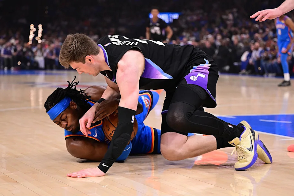 OKLAHOMA CITY, OKLAHOMA - APRIL 5: Luguentz Dort #5 of the Oklahoma City Thunder and Kyle Filipowski #22 of the Utah Jazz battle for the ball during the first half at Paycom Center on April 5, 2026 in Oklahoma City, Oklahoma. NOTE TO USER: User expressly acknowledges and agrees that, by downloading and or using this photograph, User is consenting to the terms and conditions of the Getty Images License Agreement. (Photo by Joshua Gateley/Getty Images)