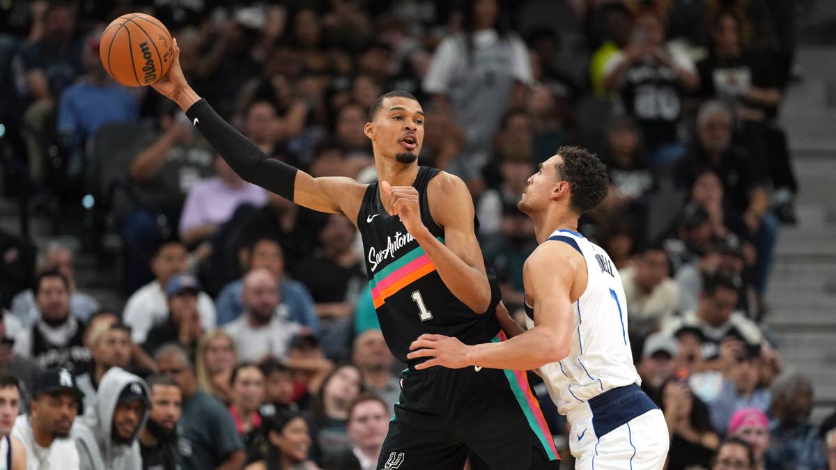 San Antonio Spurs forward Victor Wembanyama (1) looks to pass the ball while defended by Dallas Mavericks forward Dwight Powell (7) during the second half at Frost Bank Center.Scott Wachter-Imagn Images