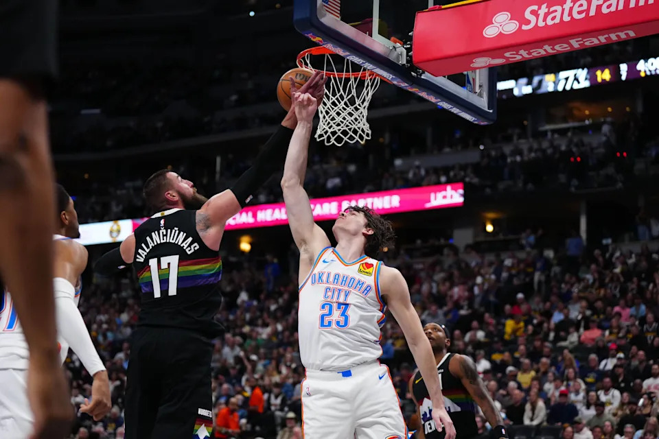 Apr 10, 2026; Denver, Colorado, USA; Oklahoma City Thunder forward Brooks Barnhizer (23) and Denver Nuggets center Jonas Valanciunas (17) battle for the ball in the second quarter at Ball Arena. Mandatory Credit: Ron Chenoy-Imagn Images