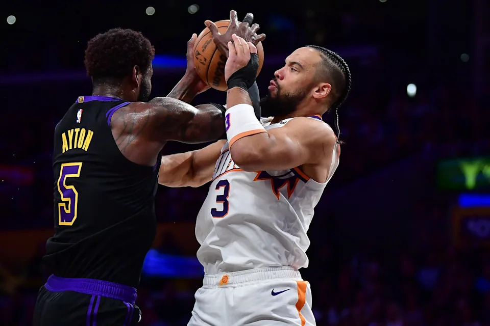 Phoenix Suns forward Dillon Brooks (3) plays for the rebound against Los Angeles Lakers center Deandre Ayton (5) during the first half at Crypto.com Arena in Los Angeles, on April 10, 2026.