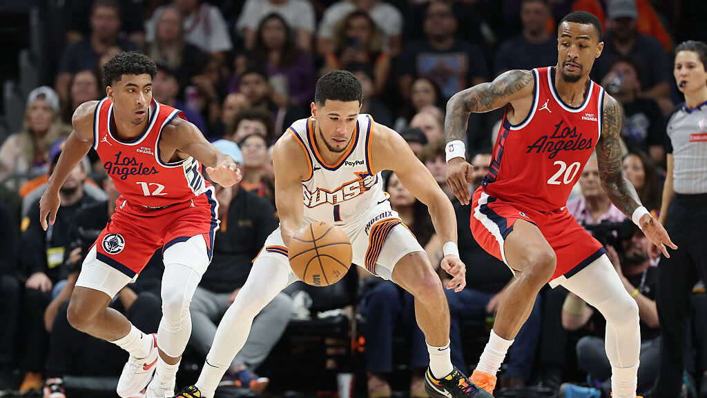 Devin Booker of the Phoenix Suns handles against the Los Angeles Clippers, who are chasing Phoenix ...