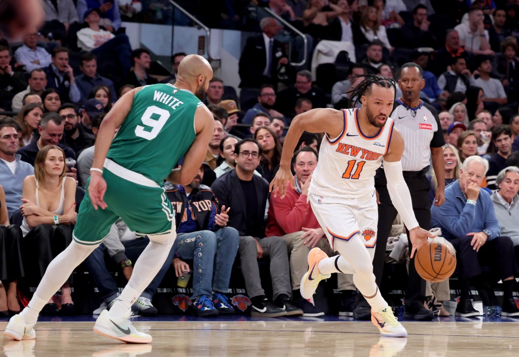 New York Knicks guard Jalen Brunson (11) drives to the basket as Boston Celtics guard Derrick White (9) gives chase.