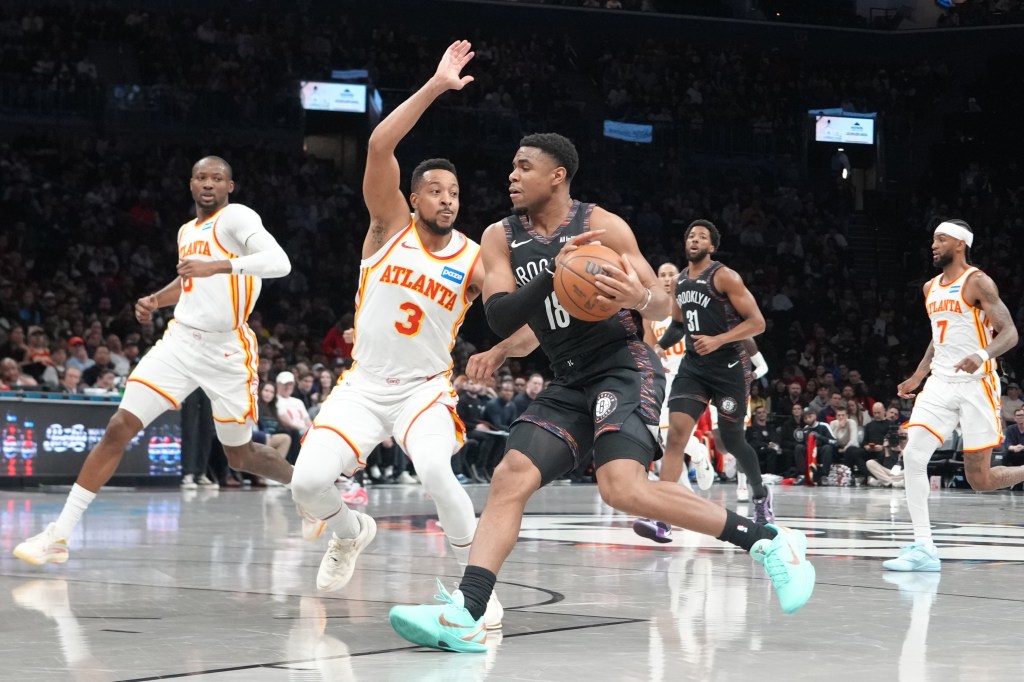 Brooklyn Nets guard Malachi Smith (18) drives the ball against Atlanta Hawks guard CJ McCollum (3) during the first half.