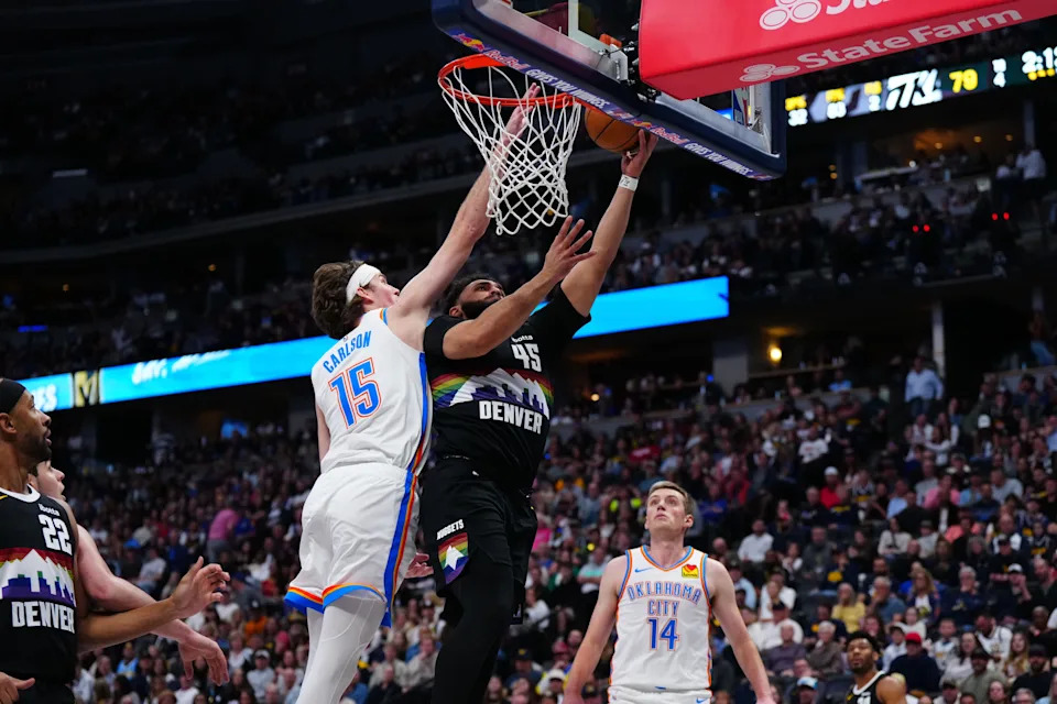 Apr 10, 2026; Denver, Colorado, USA; Denver Nuggets forward David Roddy (45) shoots the ball past Oklahoma City Thunder center Branden Carlson (15) in the second half at Ball Arena. Mandatory Credit: Ron Chenoy-Imagn Images