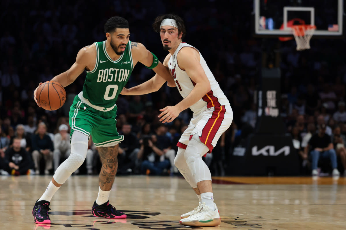 Boston Celtics forward Jayson Tatum drives to the basket against Jaime Jaquez Jr. at Kaseya Center. Sam Navarro-Imagn Images