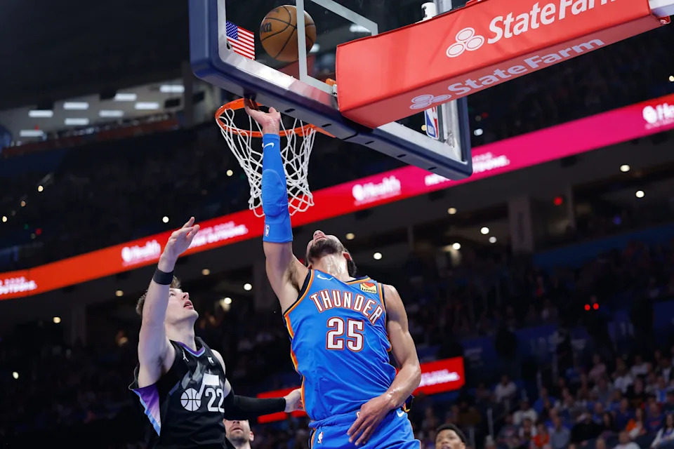 Apr 5, 2026; Oklahoma City, Oklahoma, USA; Oklahoma City Thunder guard Ajay Mitchell (25) goes up for a basket beside Utah Jazz forward Kyle Filipowski (22) during the second quarter at Paycom Center. Mandatory Credit: Alonzo Adams-Imagn Images