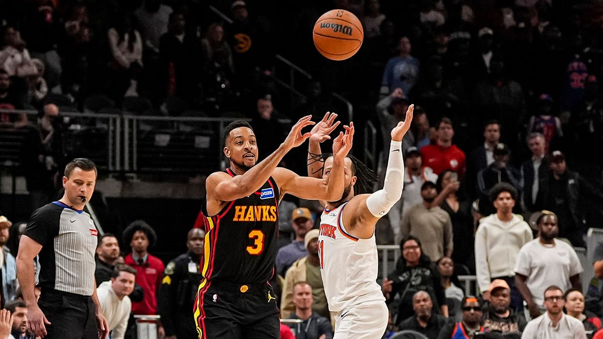 Atlanta Hawks guard CJ McCollum shooting a basketball beyond half court at State Farm Arena