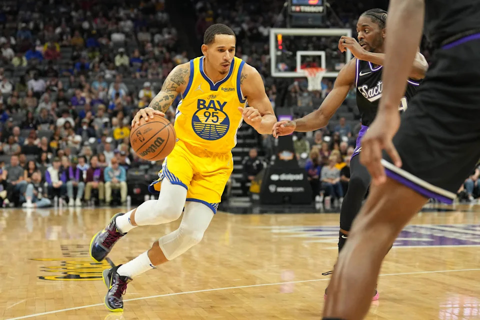 Apr 3, 2022; Sacramento, California, USA; Golden State Warriors forward Juan Toscano-Anderson (95) dribbles against Sacramento Kings forward Justin Holiday (9) during the second quarter at Golden 1 Center. Mandatory Credit: Darren Yamashita-USA TODAY Sports