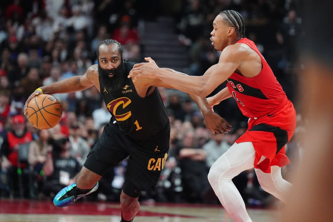 Cleveland Cavaliers guard James Harden (1) tries to get around Toronto Raptors forward Scottie Barnes, right, during the first half of Game 4 in a first-round NBA basketball playoffs series in Toronto, Sunday, April 26, 2026. (Frank Gunn/The Canadian Press via AP)