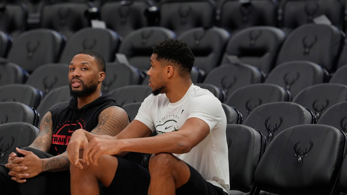 Damian Lillard #0 of the Portland Trail Blazers and Giannis Antetokounmpo #34 of the Milwaukee Bucks talk at Fiserv Forum on November 24, 2025.