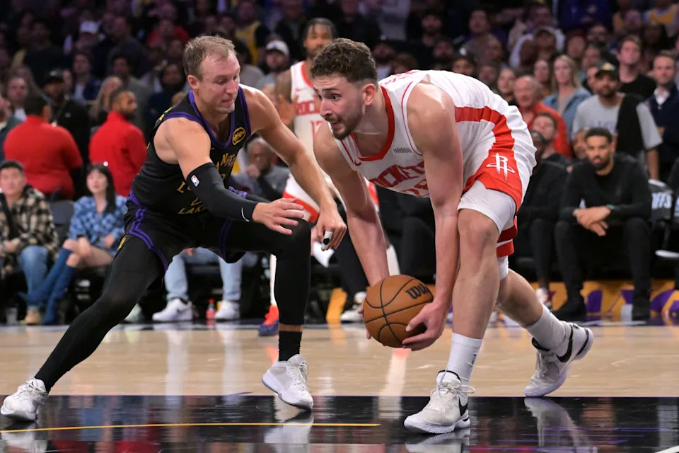 Apr 21, 2026; Los Angeles, California, USA; Los Angeles Lakers guard Luke Kennard (10) defends Houston Rockets center Alperen Sengun (28) after a reoubnd during the second half of game two of the first round of the 2026 NBA Playoffs at Crypto.com Arena. Mandatory Credit: Jayne Kamin-Oncea-Imagn Images