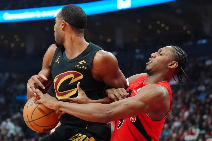 Toronto Raptors forward RJ Barrett (9) strips the ball from Cleveland Cavaliers centre Evan Mobley (4) during first half NBA playoff basketball action in Toronto on Sunday, April 26, 2026. (Frank Gunn/The Canadian Press via AP)