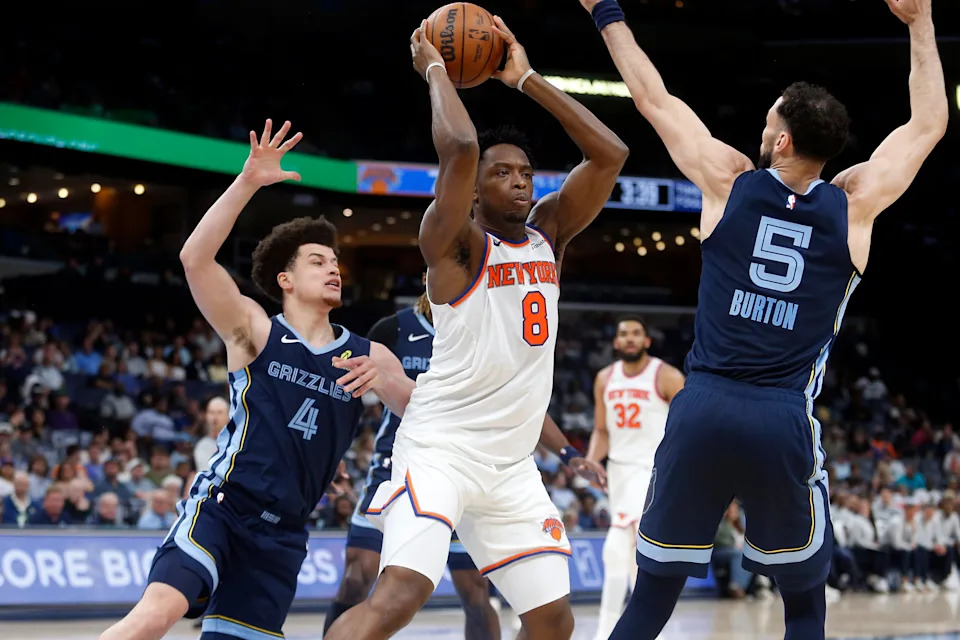 Apr 1, 2026; Memphis, Tennessee, USA; New York Knicks forward OG Anunoby (8) handles the ball as Memphis Grizzlies guard Walter Clayton Jr. (4) and forward Tyler Burton (5) defend during the second quarter at FedExForum. Mandatory Credit: Petre Thomas-Imagn Images