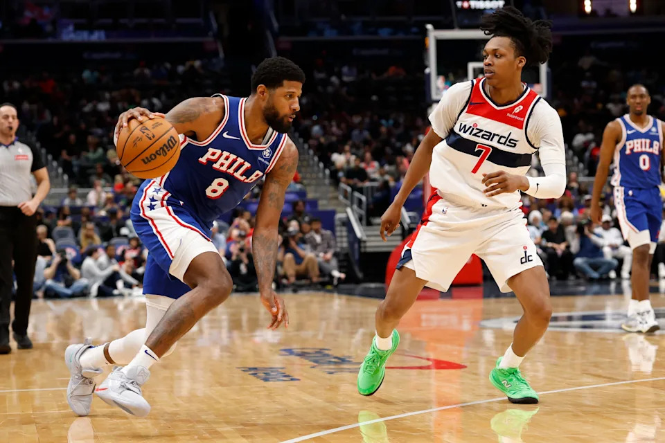 Apr 1, 2026; Washington, District of Columbia, USA; Philadelphia 76ers forward Paul George (8) drives to the basket as Washington Wizards guard Bub Carrington (7) defends in the first half at Capital One Arena. Mandatory Credit: Geoff Burke-Imagn Images