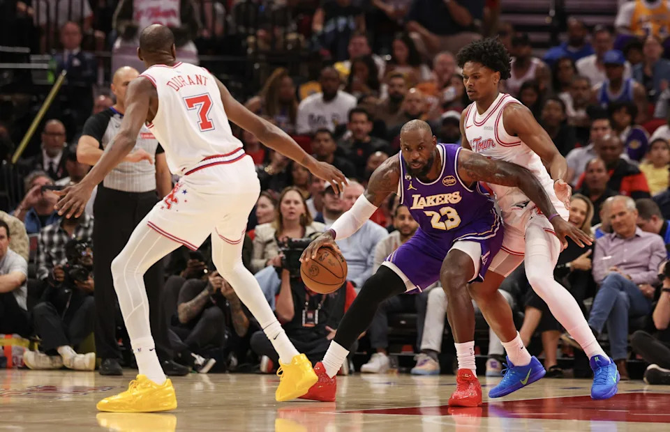 Mar 18, 2026; Houston, Texas, USA; Los Angeles Lakers forward LeBron James (23) dribbles against Houston Rockets guard Amen Thompson (1) and forward Kevin Durant (7) in the first quarter at Toyota Center. Mandatory Credit: Thomas Shea-Imagn Images