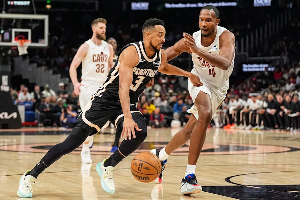 Atlanta Hawks guard CJ McCollum (3) drives past Cleveland Cavaliers center Evan Mobley (4) on April 10, 2026, in Atlanta, Georgia.