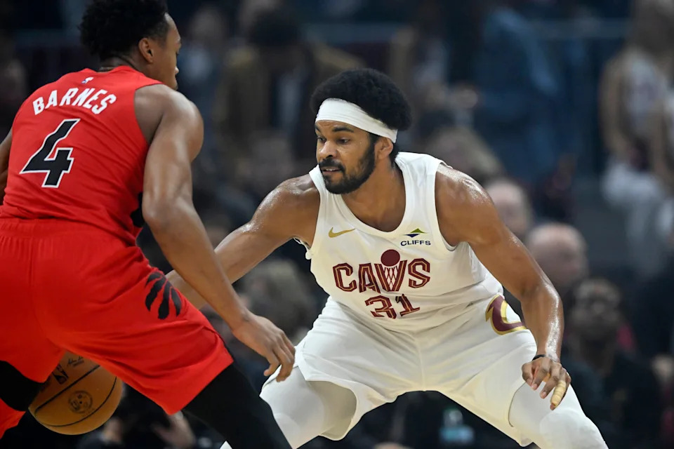 Nov 13, 2025; Cleveland, Ohio, USA; Cleveland Cavaliers center Jarrett Allen (31) defends Toronto Raptors forward Scottie Barnes (4) in the first quarter at Rocket Arena. Mandatory Credit: David Richard-Imagn Images