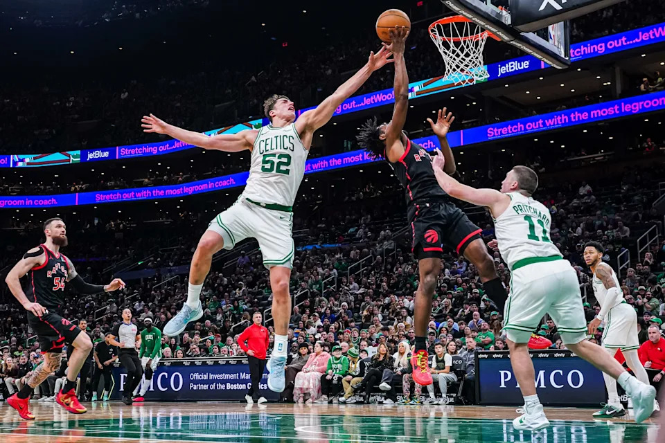 Jan 9, 2026; Boston, Massachusetts, USA; Boston Celtics center Luka Garza (52) and guard Payton Pritchard (11) defend against Toronto Raptors guard Immanuel Quickley (5) in the second half at TD Garden. Mandatory Credit: David Butler II-Imagn Images